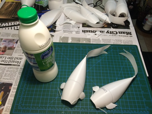 One Yoghurt bottle cut into two lengthwise is enough to create 2 Koi fishes. The bottom piece of the bottle was used as the tail.