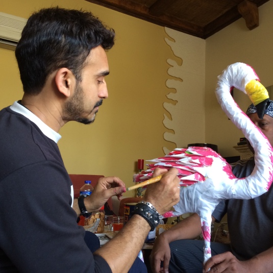 Artist Dr. Sreekumar painting the flamingo body, which was constructed out of plastic shopping bags.