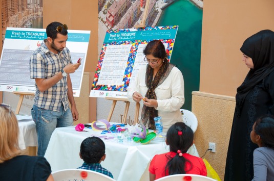 Artist Smita Aloni demonstrating to participants - making flowers and butterflies from plastic bottles.