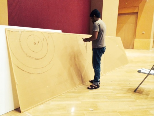 Artist Mahesh marking out the backdrop piece.